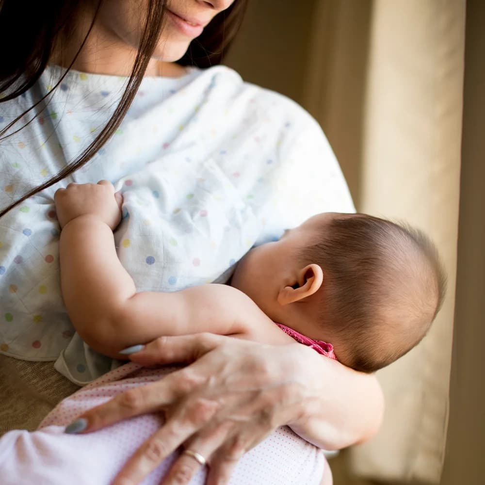 A Mother holding her new born baby