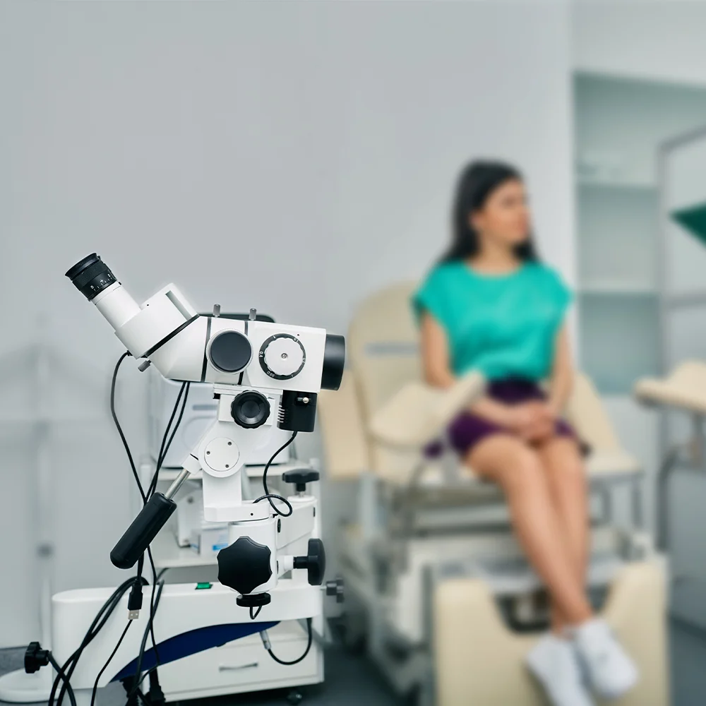 Colposcope equipment with a patient in an examination room