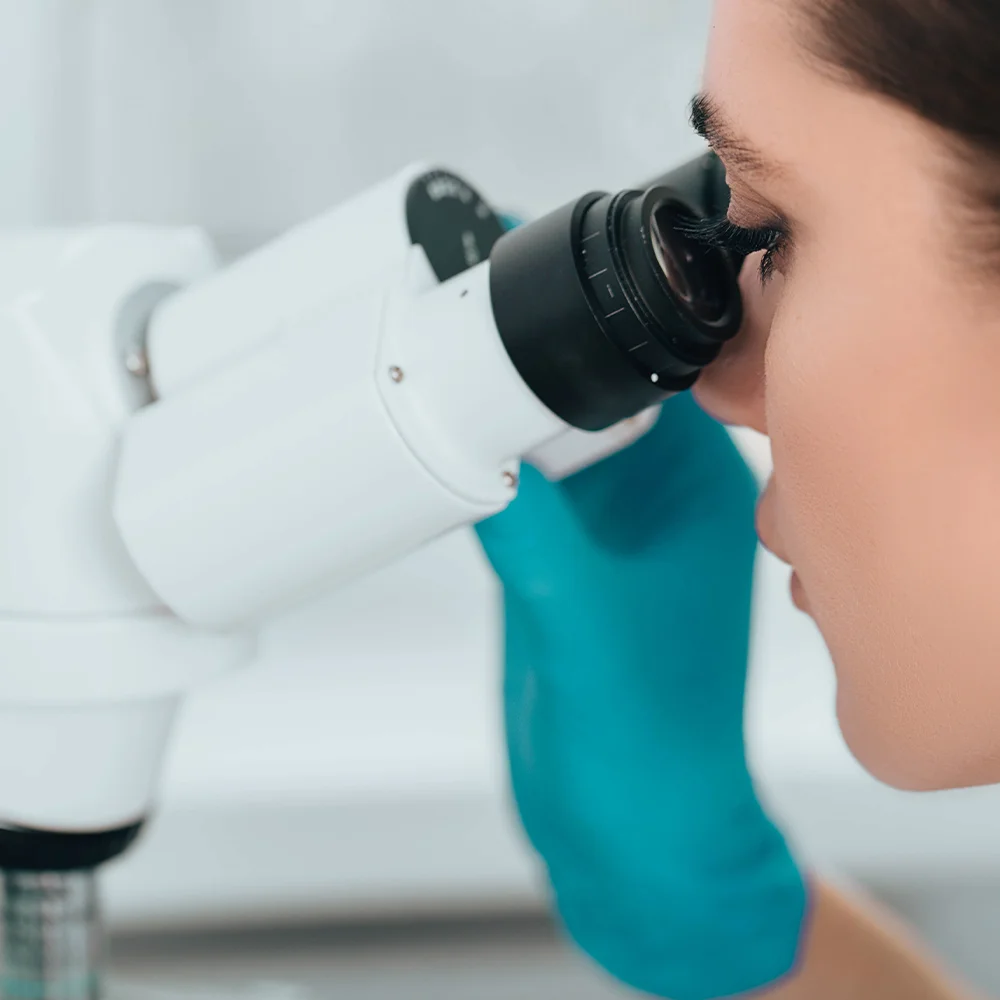 Consultant examining with colposcope equipment