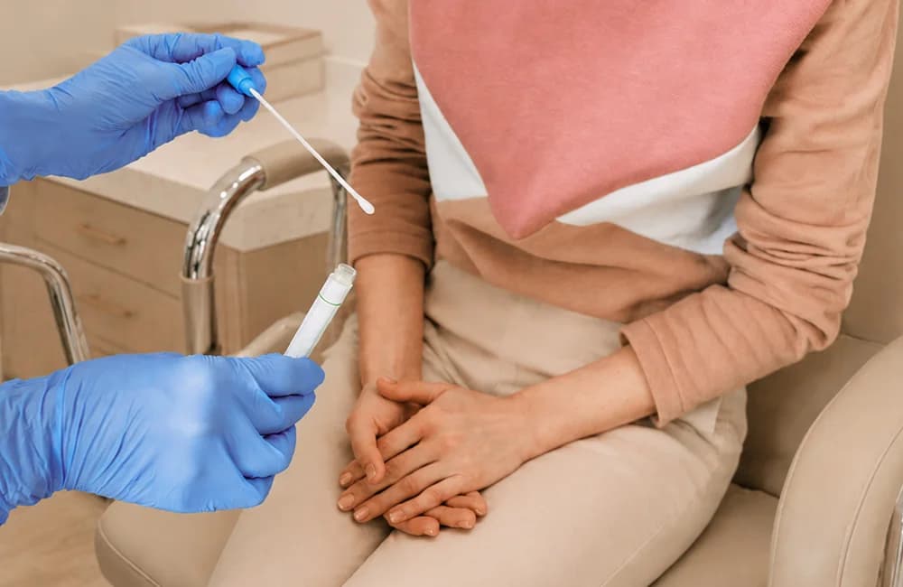 Consultant taking a swab sample from a patient