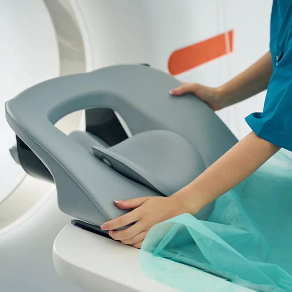 Healthcare professional positioning MRI coil equipment