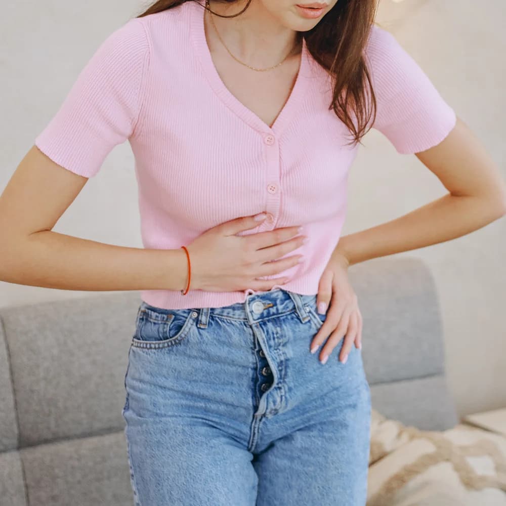 Woman experiencing abdominal discomfort