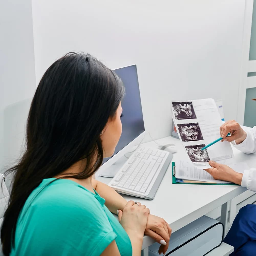 Woman discussing pelvic pain with her consultant