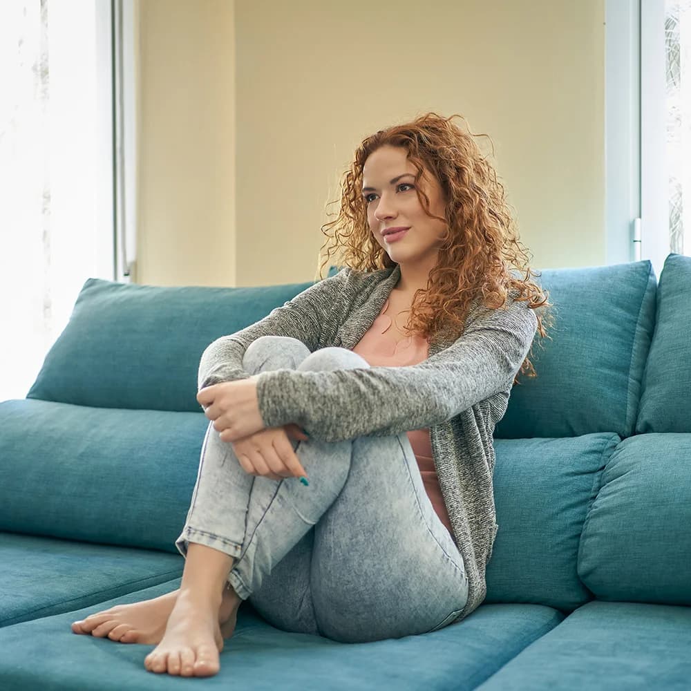 Woman relaxing at home on a sofa