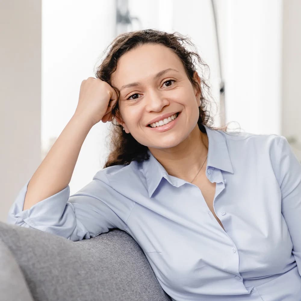 Smiling woman leaning on couch