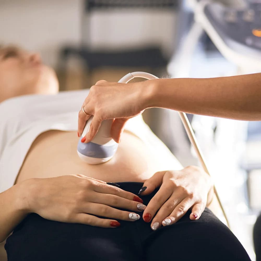 Consultant performing a pelvic ultrasound scan on a patient