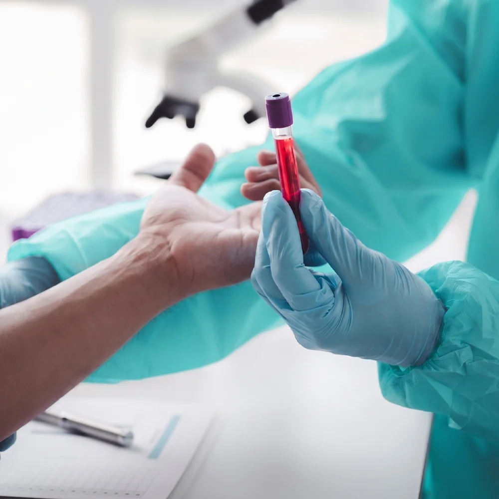 Consultant handing over a blood test sample