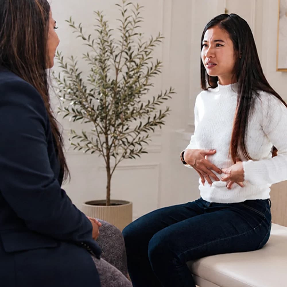 Consultant discussing symptoms with a patient
