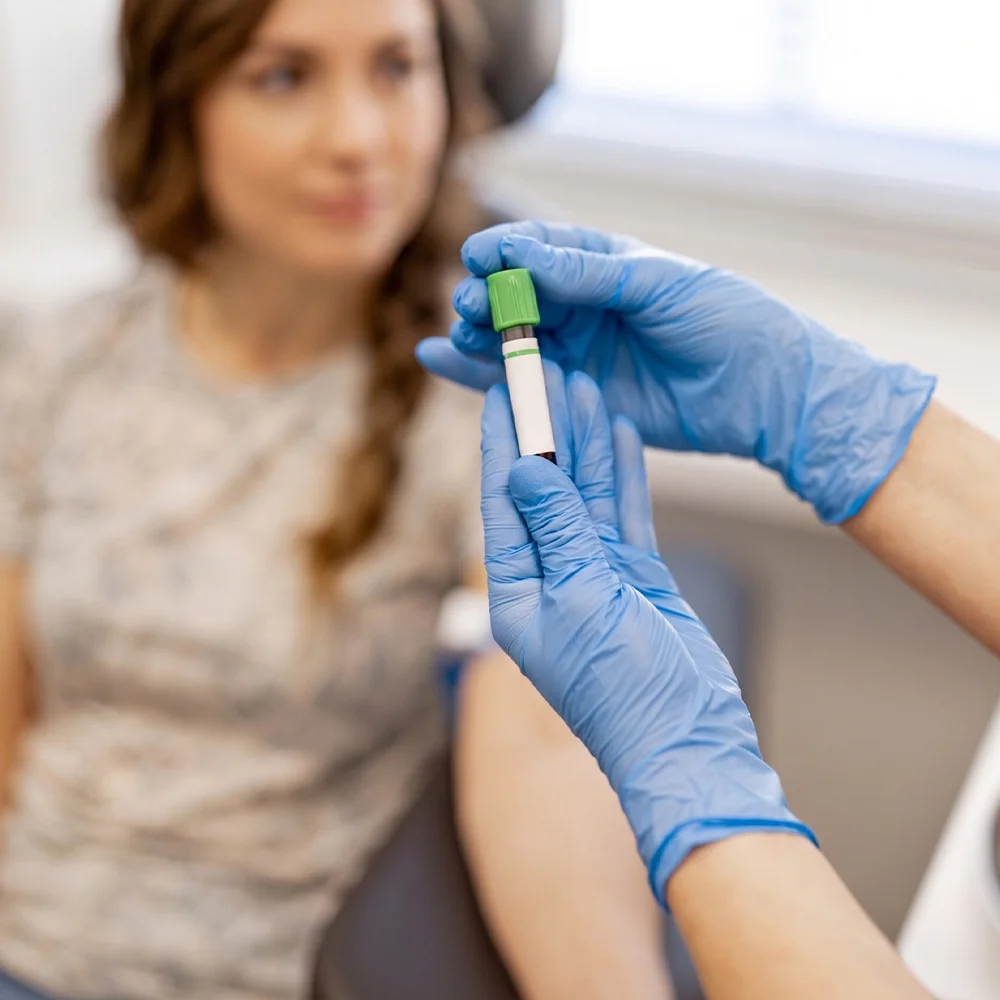 Consultant holding a blood test sample