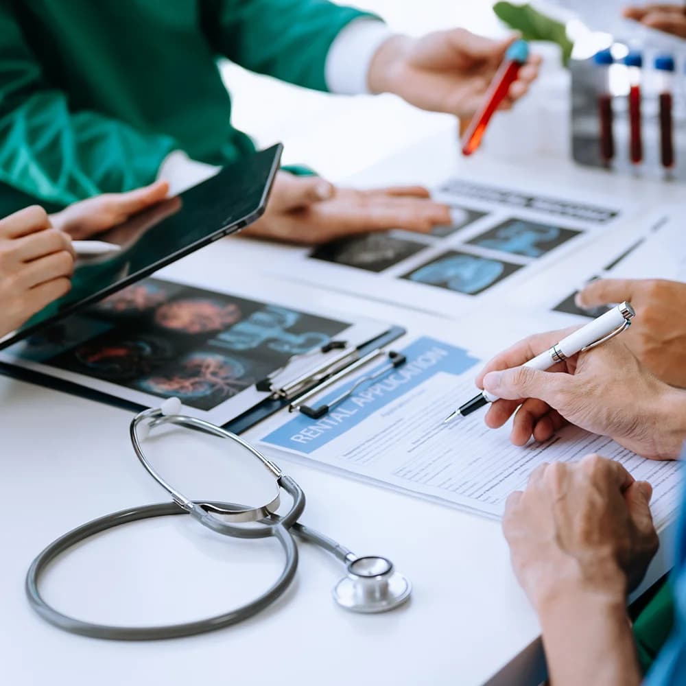 Doctor writing on a referral form
