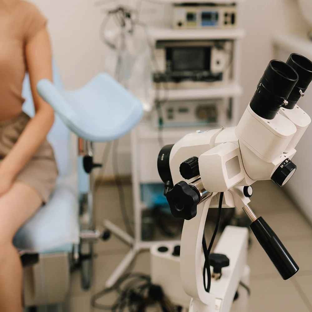 Colposcope equipment with a patient in an examination room