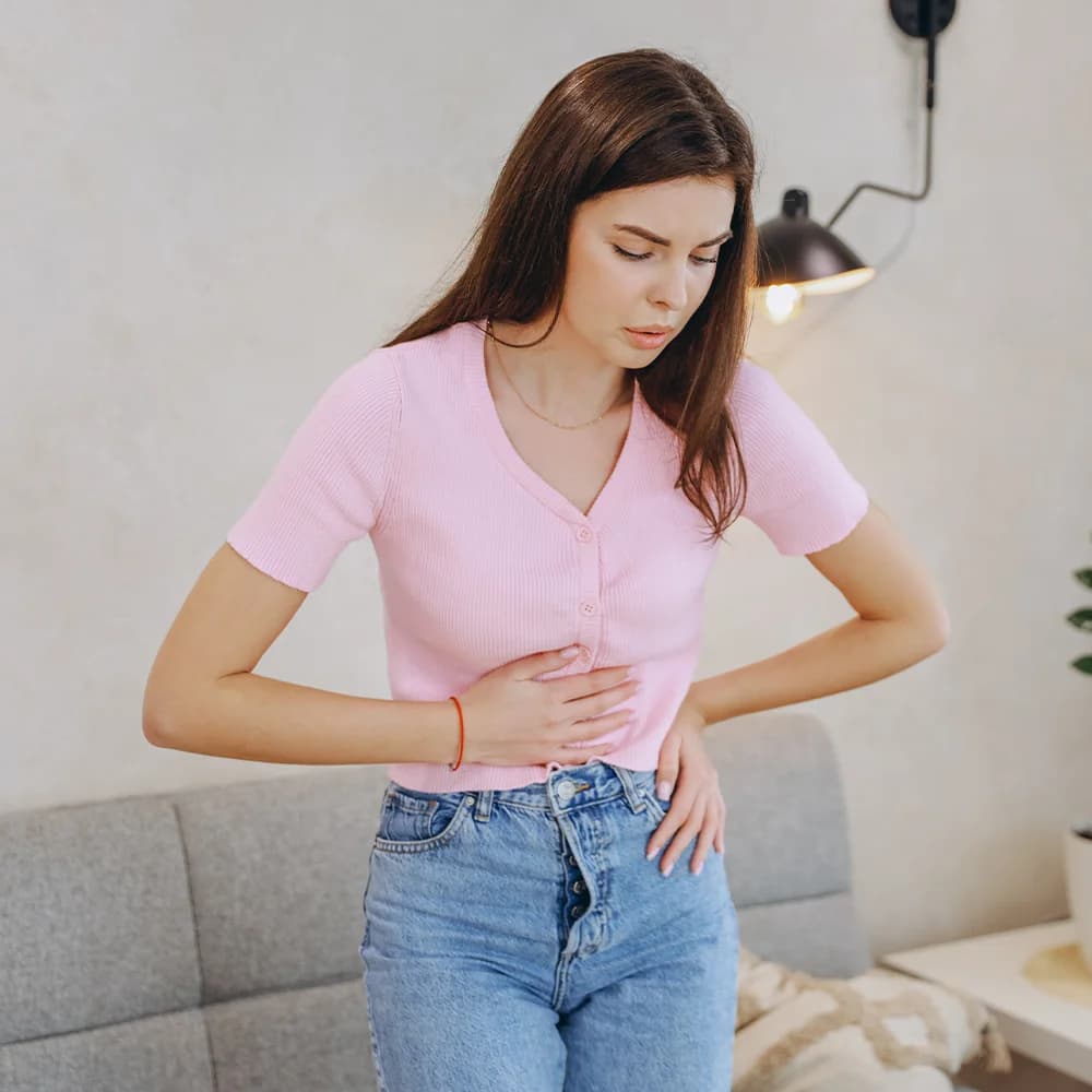 Woman experiencing symptoms associated with PCOS